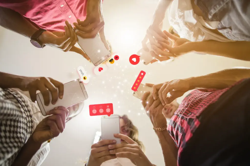 Group of people using smartphones with social icons representing interactive social media marketing campaigns.